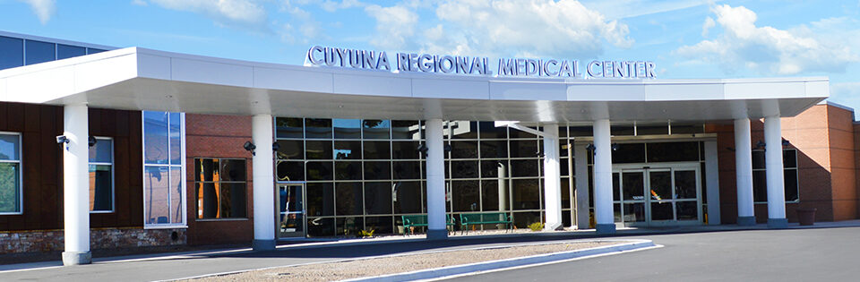 Front entrance of Cuyuna Regional Medical Center in Crosby, Minnesota, with large glass windows and white columns