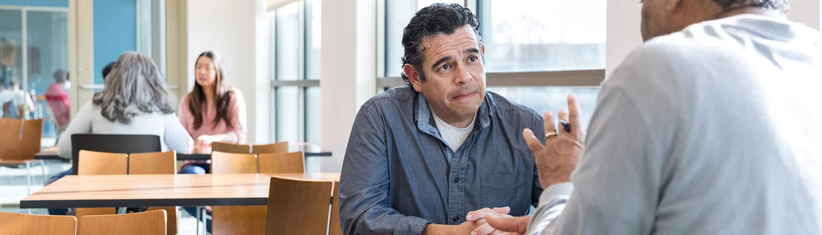 Mature Man Listens Intently To The Financial Advisor As He Gives Him Some Valuable Advice