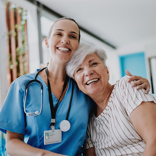 Young nurse and her patient share a light-hearted moment.