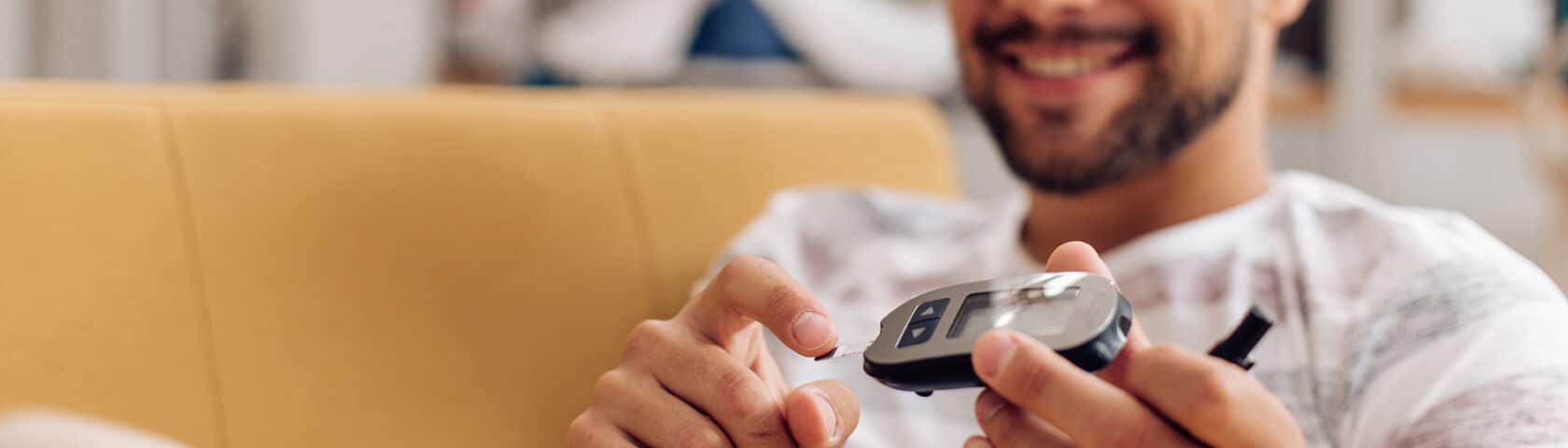 Portrait Of A Young Man Measuring His Insulin Level At Home