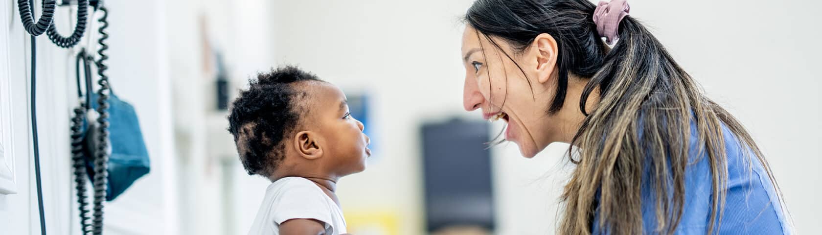 Baby gets a checkup with a friendly nurse.