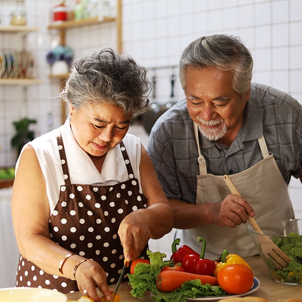 Happiness Senior Elderly Couple Having Fun In Kitchen With Healthy Food For Working From Home. Covid 19