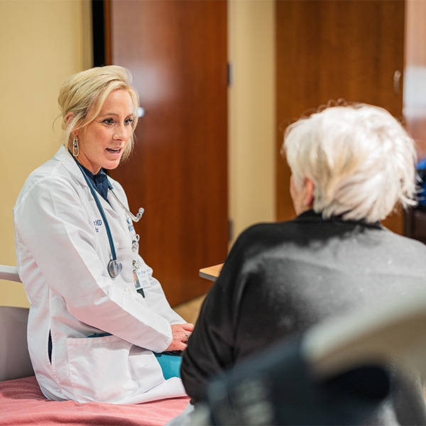 CRMC provider talks with an older patient.