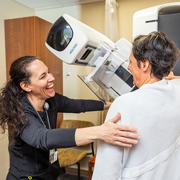 CRMC provider helps a patient with an exam.