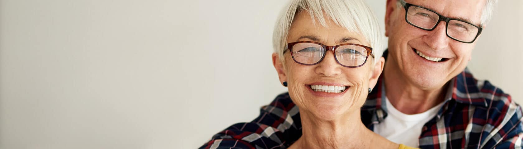 Elderly couple smiles and enjoys a moment together.