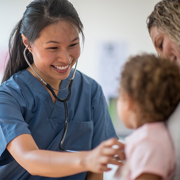 CRMC provider listens to the heartbeat of a young patient.