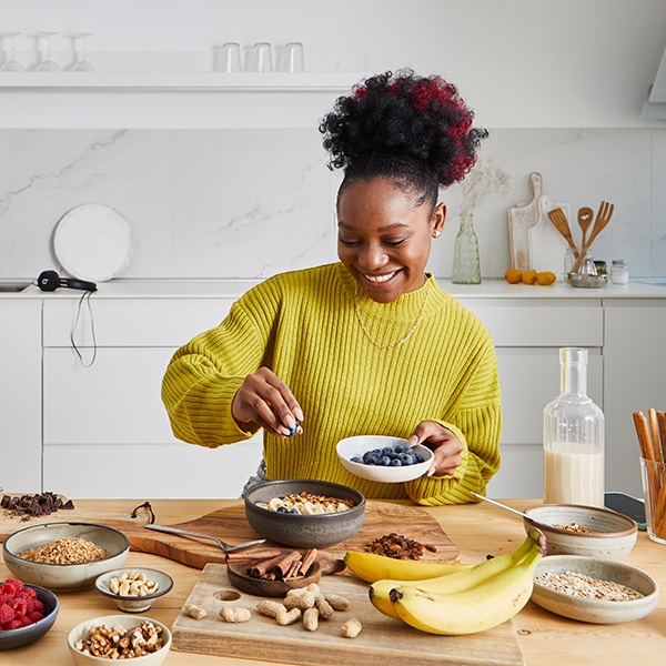 Woman enjoys cooking a healthy meal in her kitchen.