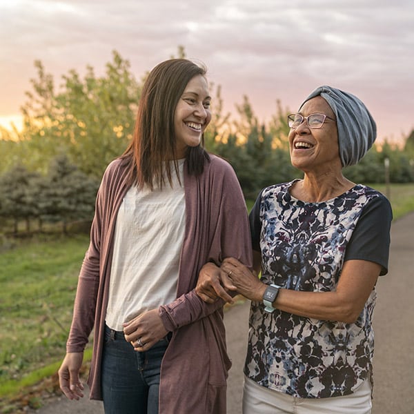 Beautiful Mixed Race Mother And Daughter Relaxing Outdoors Together