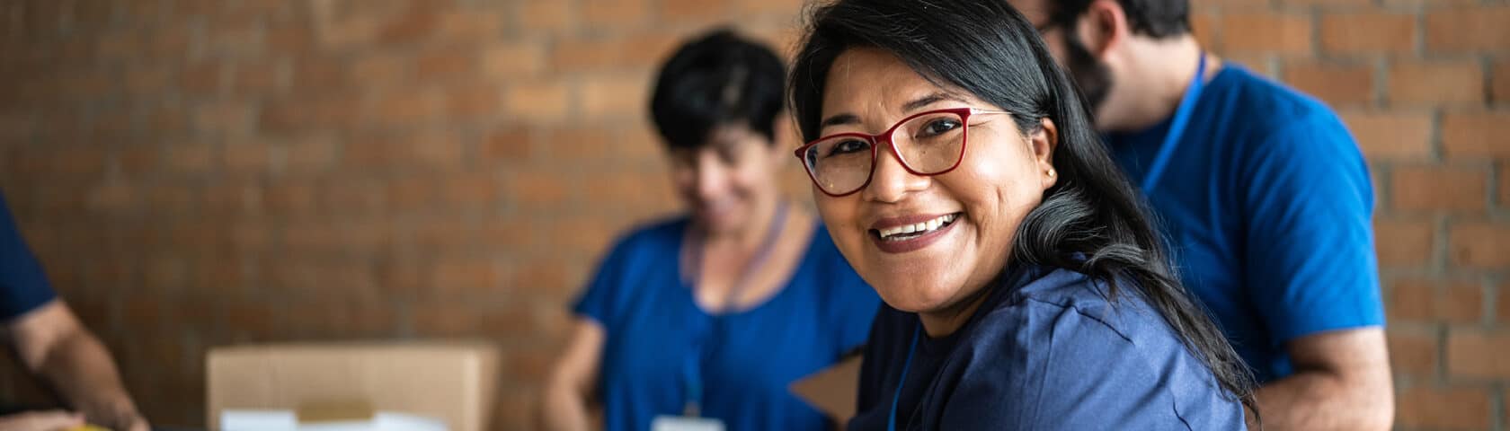 Portrait Of A Volunteer Working In A Community Charity Donation Center
