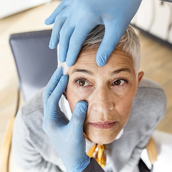 Senior Patient Having An Eye Exam At Ophthalmologist's Office