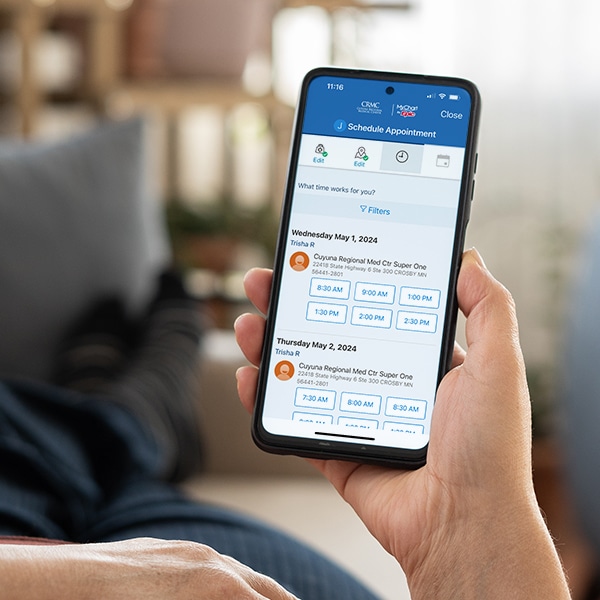 Woman Using Phone With White Screen While Lying On Sofa At Home , Mock Up Screen