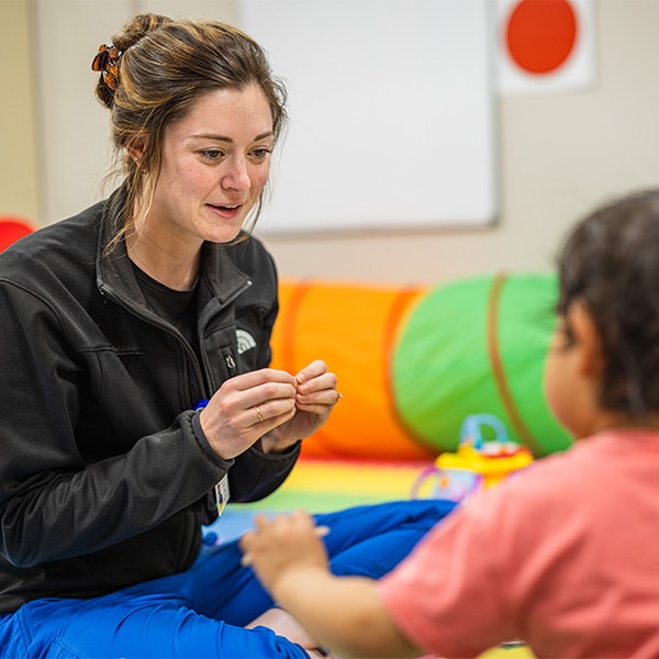 CRMC provider helps a young patient through play therapy.