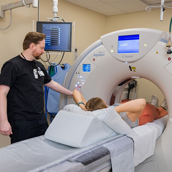 CRMC radiology tech helps a patient through their scan.