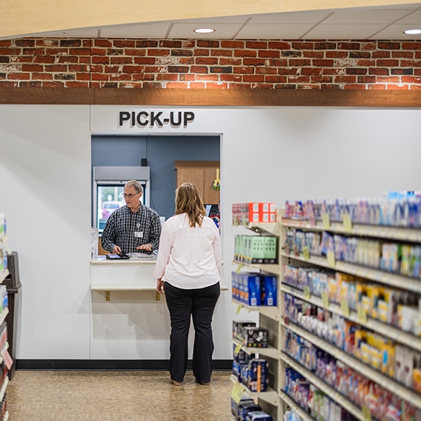 Woman picks up her prescriptions at CRMC Crosby pharmacy.