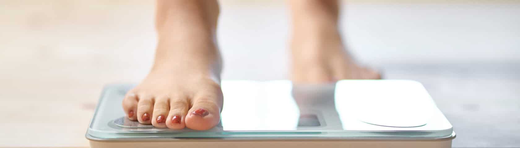 Feet Of An Asian Woman On A Weight Scale