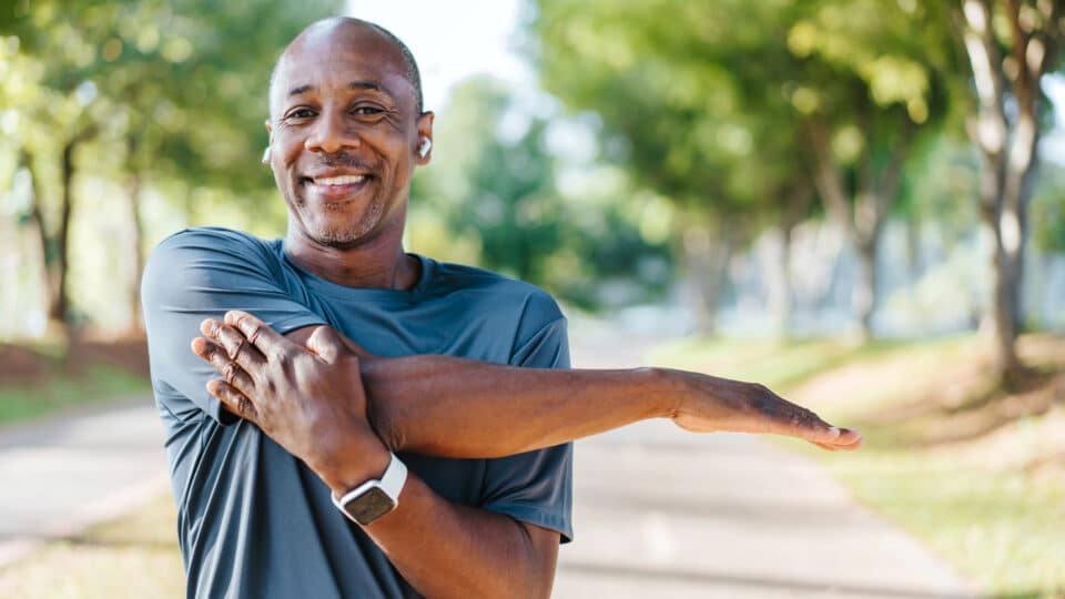 Portrait Of A Mature Man Doing Stretching In Public Park