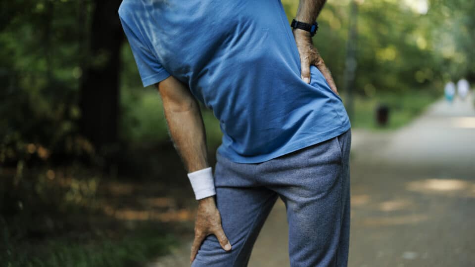 Senior Man Runner With Knee Pain In The Park