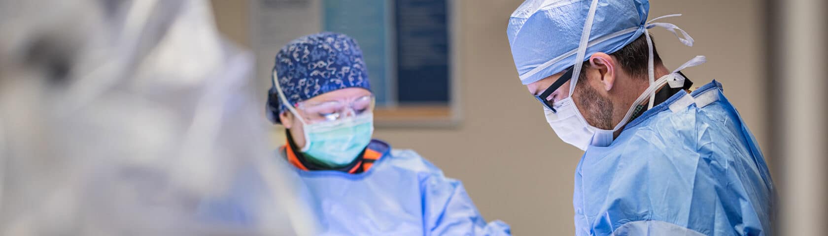 Two CRMC providers performing a surgical procedure.