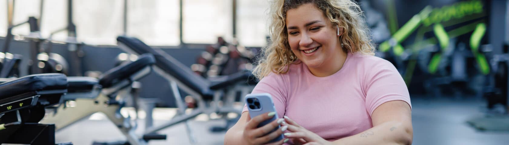 Woman Checking Phone During Gym Break