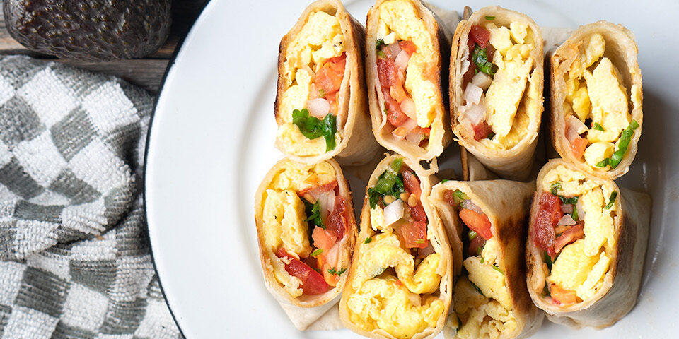 Breakfast burrito served on a plate with fresh toppings as part of a healthy, balanced breakfast option.
