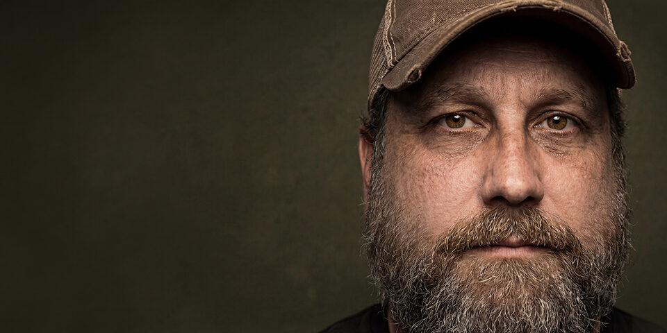 Woman smiling confidently, highlighting the importance of colon cancer screening and preventive healthcare at age 45 and older.