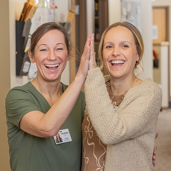 CRMC provider consults with an older woman in a clinic.