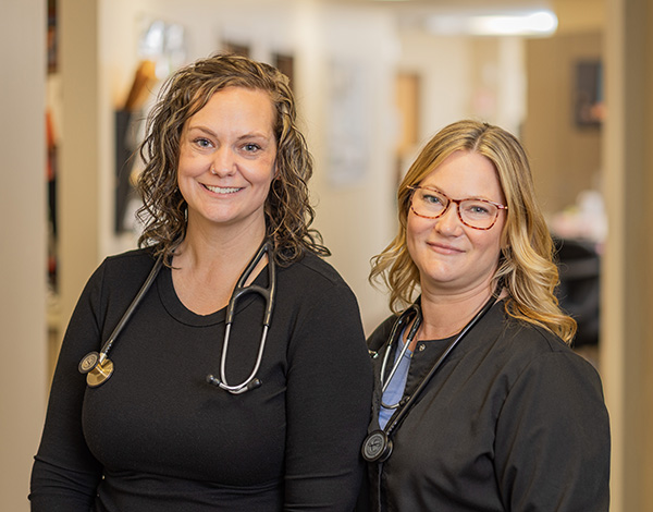 CRMC provider listens to the heart beat of a smiling patient.