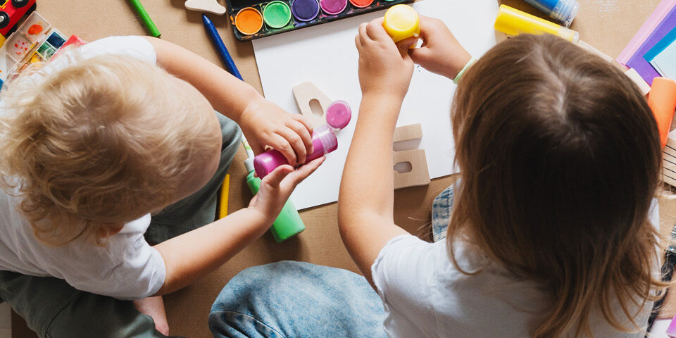 Children doing crafts with small toys, supporting CRMC’s message on safe, age-appropriate holiday gift choices.