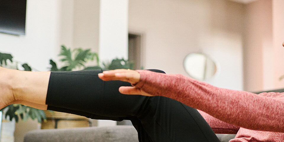 Woman performing pelvic floor or core exercises at home, illustrating non-surgical treatment options for urinary incontinence.