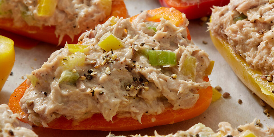 Halved bell peppers filled with a creamy shredded chicken mixture and topped with everything bagel seasoning, illustrating a quick 4-ingredient meal prep recipe.
