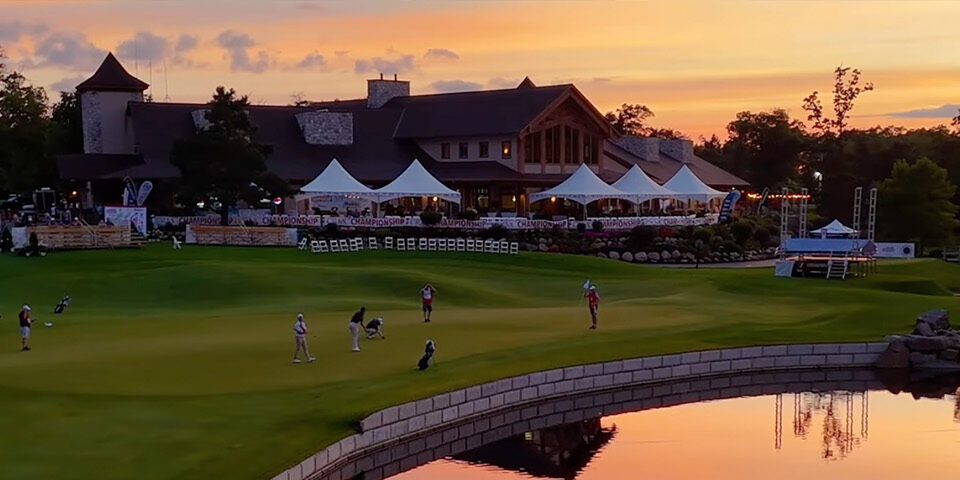 CRMC Championship Golf Tournament at Cragun’s Legacy Courses during sunset, with players on the green and white tents near the clubhouse.