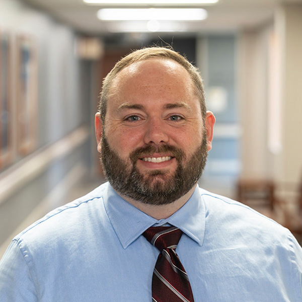 Dr. Graham Fain, DO, Internal Medicine and Hospitalist physician at Cuyuna Regional Medical Center (CRMC), smiling in the hallway.