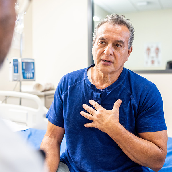 Man describing stomach discomfort to a doctor during a medical consultation for Gastroparesis.