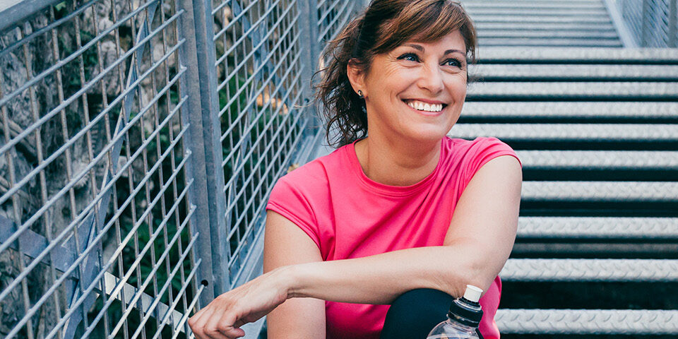 Woman smiling after a wellness screening, representing CRMC’s free breast and cervical cancer screening event.