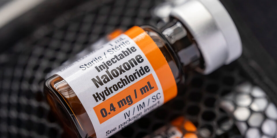 Close-up of an injectable naloxone hydrochloride vial used to reverse opioid overdoses, representing CRMC’s lifesaving overdose prevention resources.