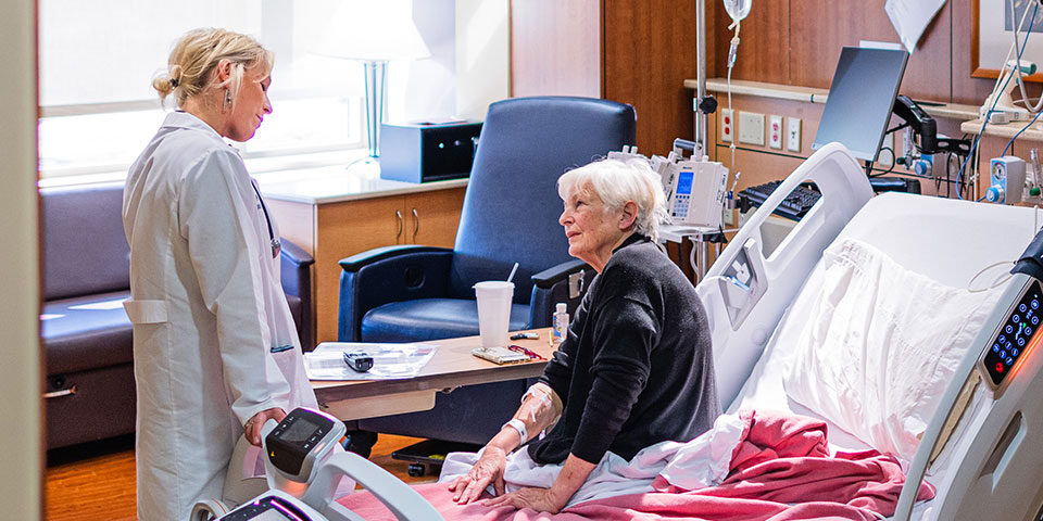 Doctor and patient in a medical-surgical hospital room at Cuyuna Regional Medical Center, highlighting patient care and hospital services.