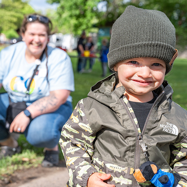 Smiling, happy kid experiencing music at the park hosted by CRMC.
